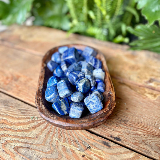 Lapis Lazuli Tumbled Crystal - Dive into the deep blue energies of Lapis Lazuli. Revered for its connection to wisdom and truth, Lapis Lazuli is believed to promote self-awareness and spiritual enlightenment.
