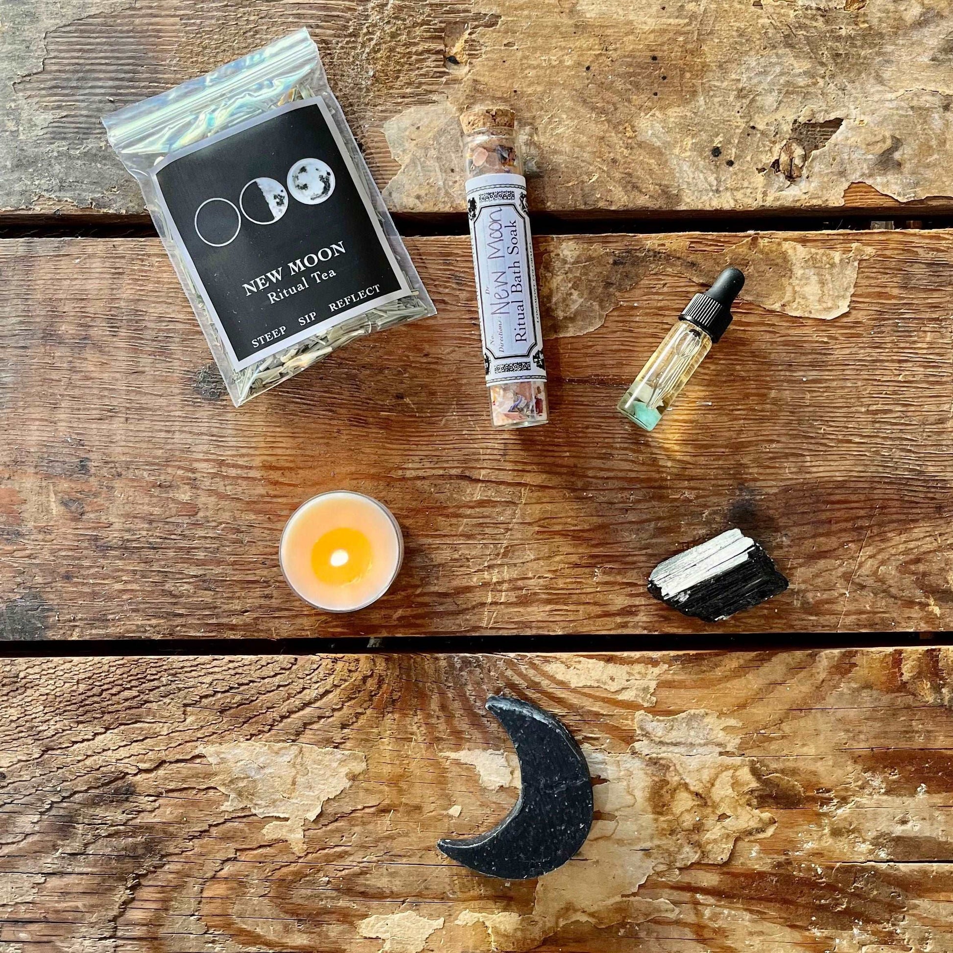 Embrace the potential of our New Moon Intention Ritual Kit. Ignite your intentions with a New Moon Intention Tea Light, indulge in self-care with New Moon Salt & Charcoal Goat's Milk Soap and Salt Soak, and set the mood with New Moon Essential Oil. Ground your energy with Rough Black Tourmaline, sip on New Moon Ritual Tea, and follow guidance from the New Moon Ritual Booklet. Welcome the lunar energy and manifest your intentions with this curated kit.