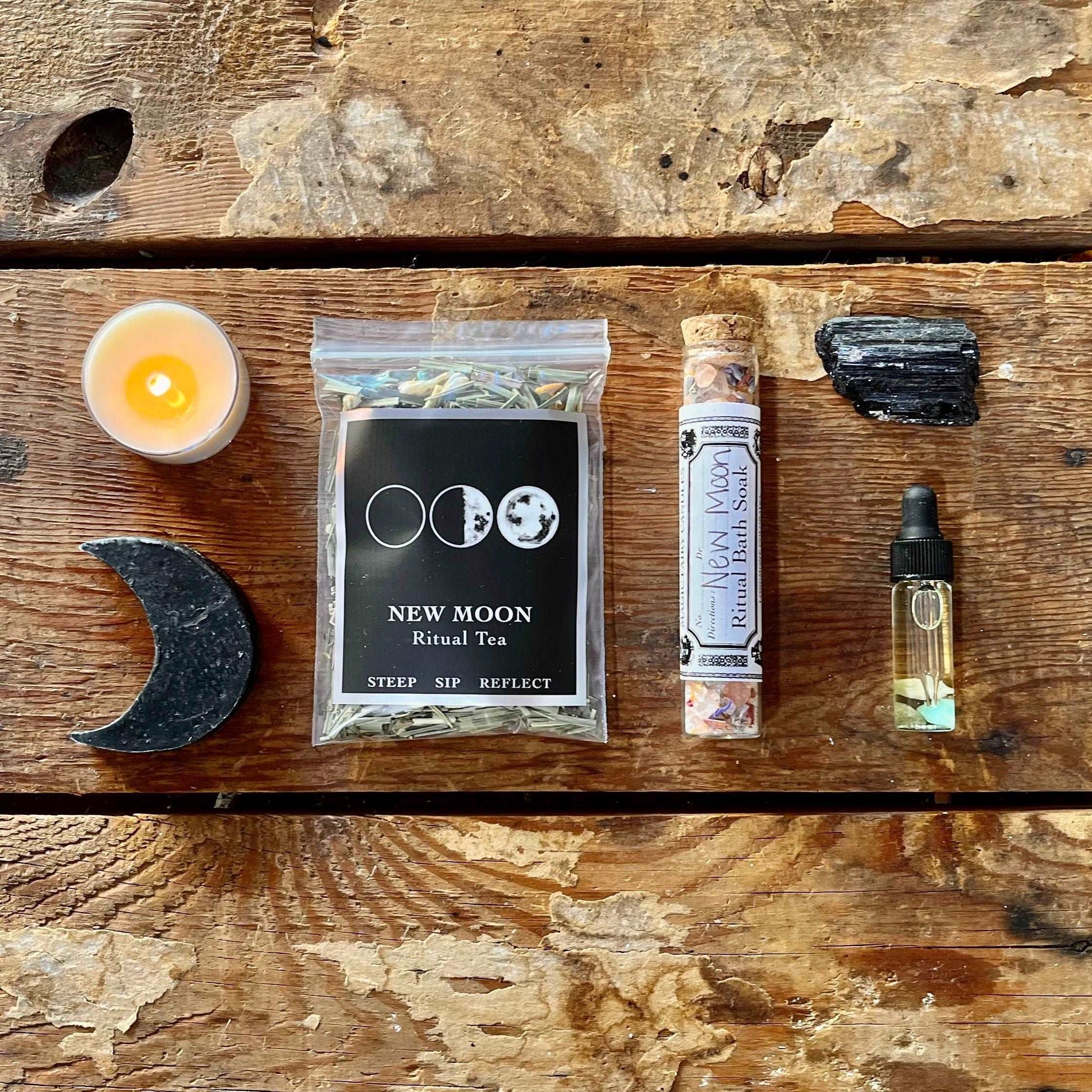 Embrace the potential of our New Moon Intention Ritual Kit. Ignite your intentions with a New Moon Intention Tea Light, indulge in self-care with New Moon Salt & Charcoal Goat's Milk Soap and Salt Soak, and set the mood with New Moon Essential Oil. Ground your energy with Rough Black Tourmaline, sip on New Moon Ritual Tea, and follow guidance from the New Moon Ritual Booklet. Welcome the lunar energy and manifest your intentions with this curated kit.