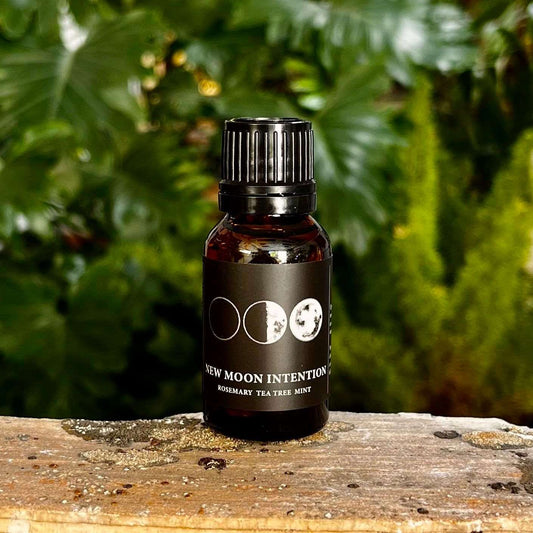 0.5 oz New Moon Intention Essential Oil Blend with a Proprietary Blend of Organic Essential Oils, Organic Fractionated Coconut Oil, and a Crystal Charged Under the New Moon for Fresh Beginnings and Clarity.